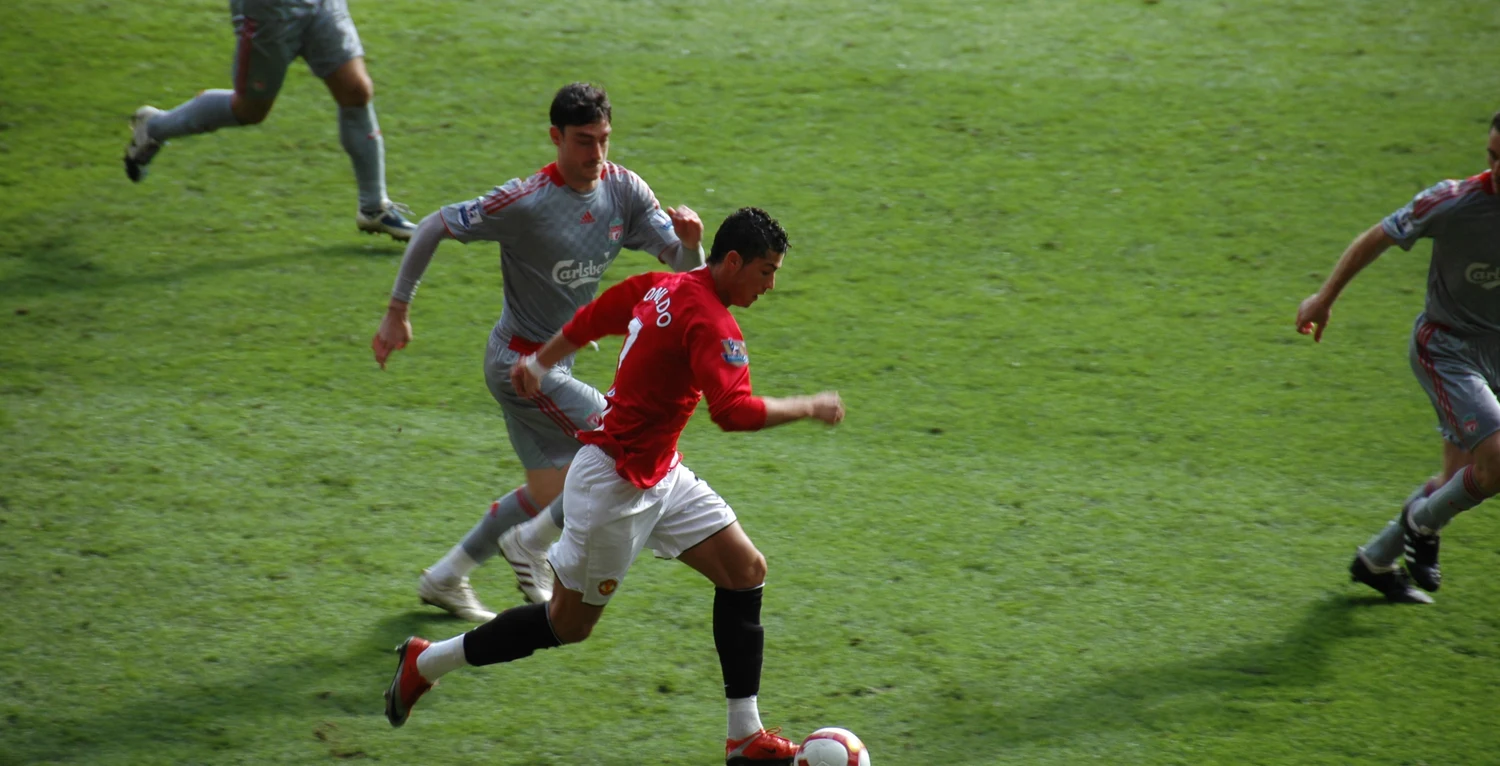 Premier League football action live broadcast on pitch.